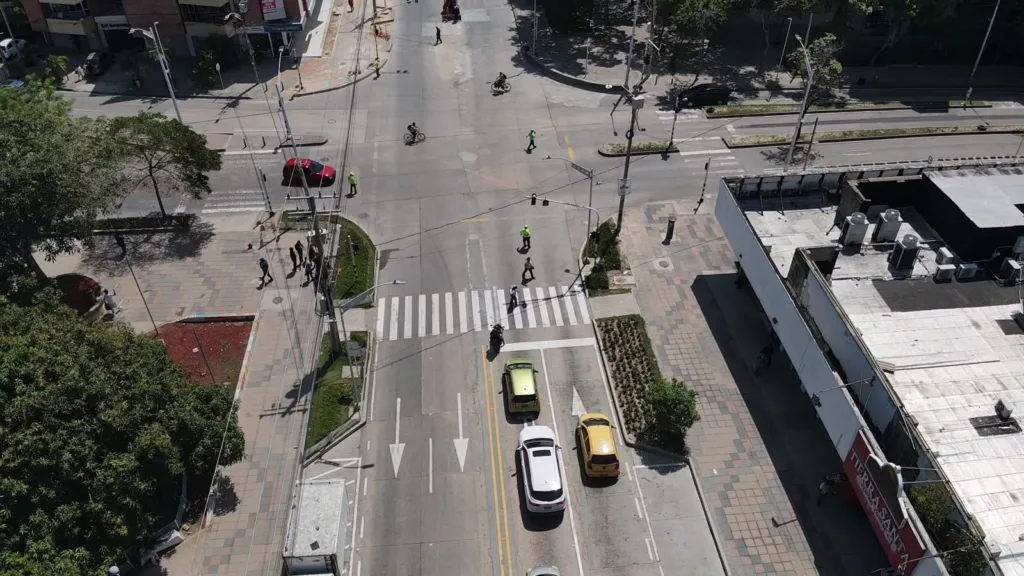 Agentes de tránsito regulan la movilidad en una intersección de la calle 72 con presencia de peatones, ciclistas y vehículos.