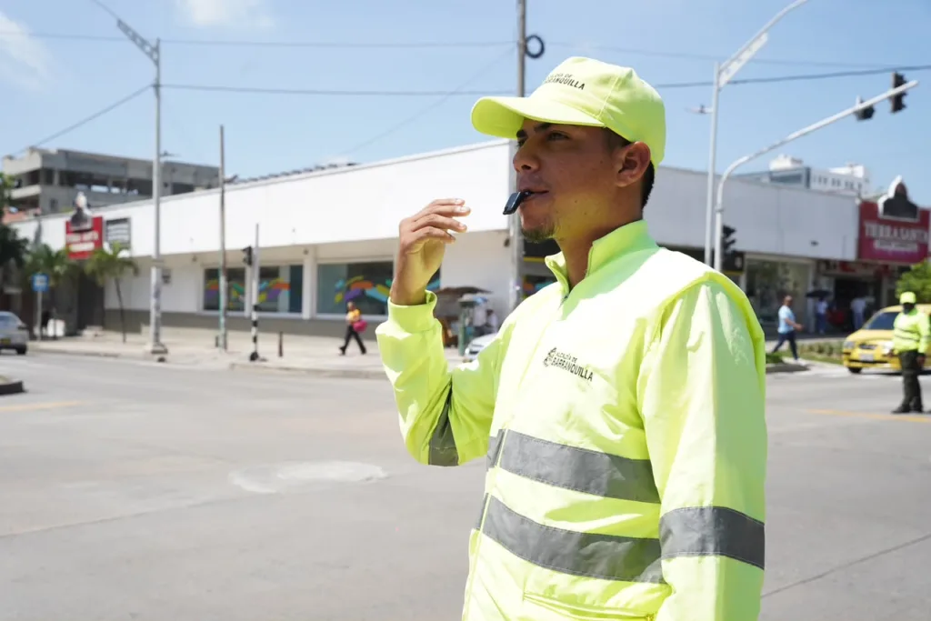 Agente de tránsito de Barranquilla dirige la movilidad en una intersección urbana.